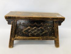 A SMALL CHINESE CARVED ELM WOOD TWO DRAWER STOOL OF SPLAYED DESIGN, DRAWERS TO EITHER END.