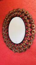 A MODERN DESIGNER METAL CRAFT OVAL WALL MIRROR OF PEACOCK FEATHER DESIGN