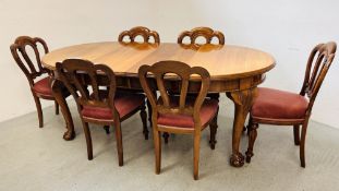 AN OVAL EXTENDING DINING TABLE WITH WIND-OUT ACTION AND TWO EXTENSION LEAVES WITH BALL AND CLAW