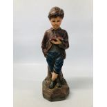 A VINTAGE POLYCHROME PLASTER STUDY OF A YOUNG BOY READING "INTERIORS No 12" HEIGHT 50CM.