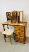 A HONEY PINE THREE DRAWER DRESSING TABLE WITH TRIPLE MIRROR AND STOOL.
