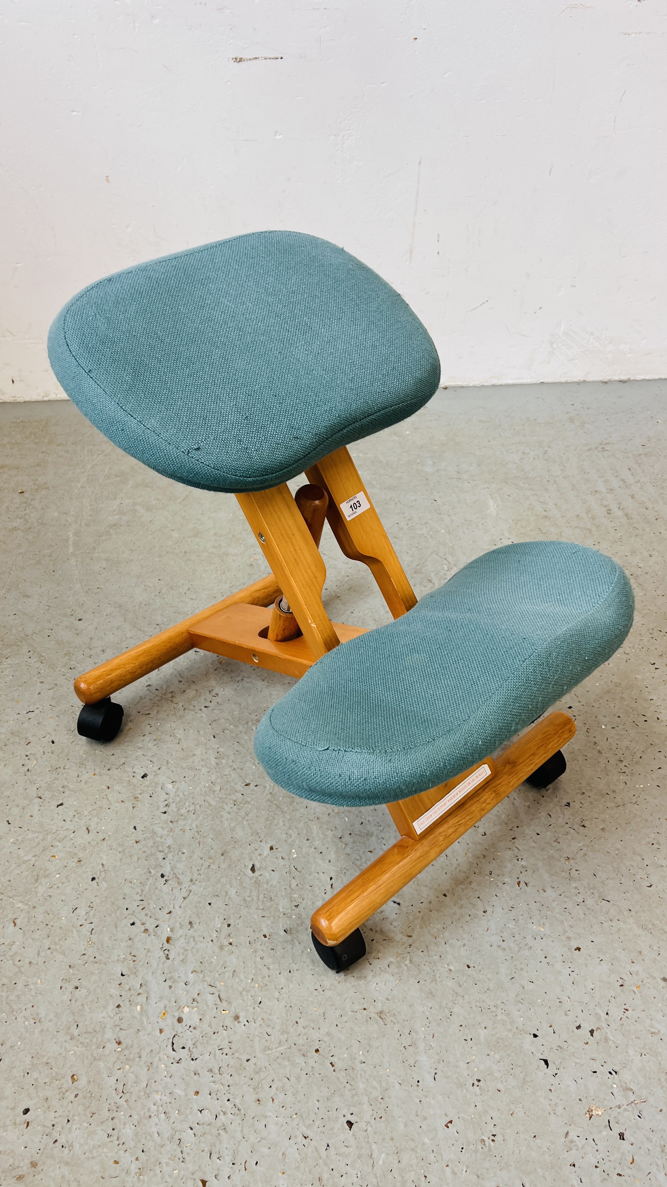 A BACK SUPPORT WHEELED KNEELING CHAIR.