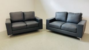 A PAIR OF GREY FAUX LEATHER TWO SEATER SOFA'S, W 144CM.