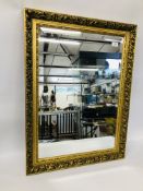 A GILT FRAMED MIRROR WITH BEVELLED PLATE GLASS 82CM X 63CM.