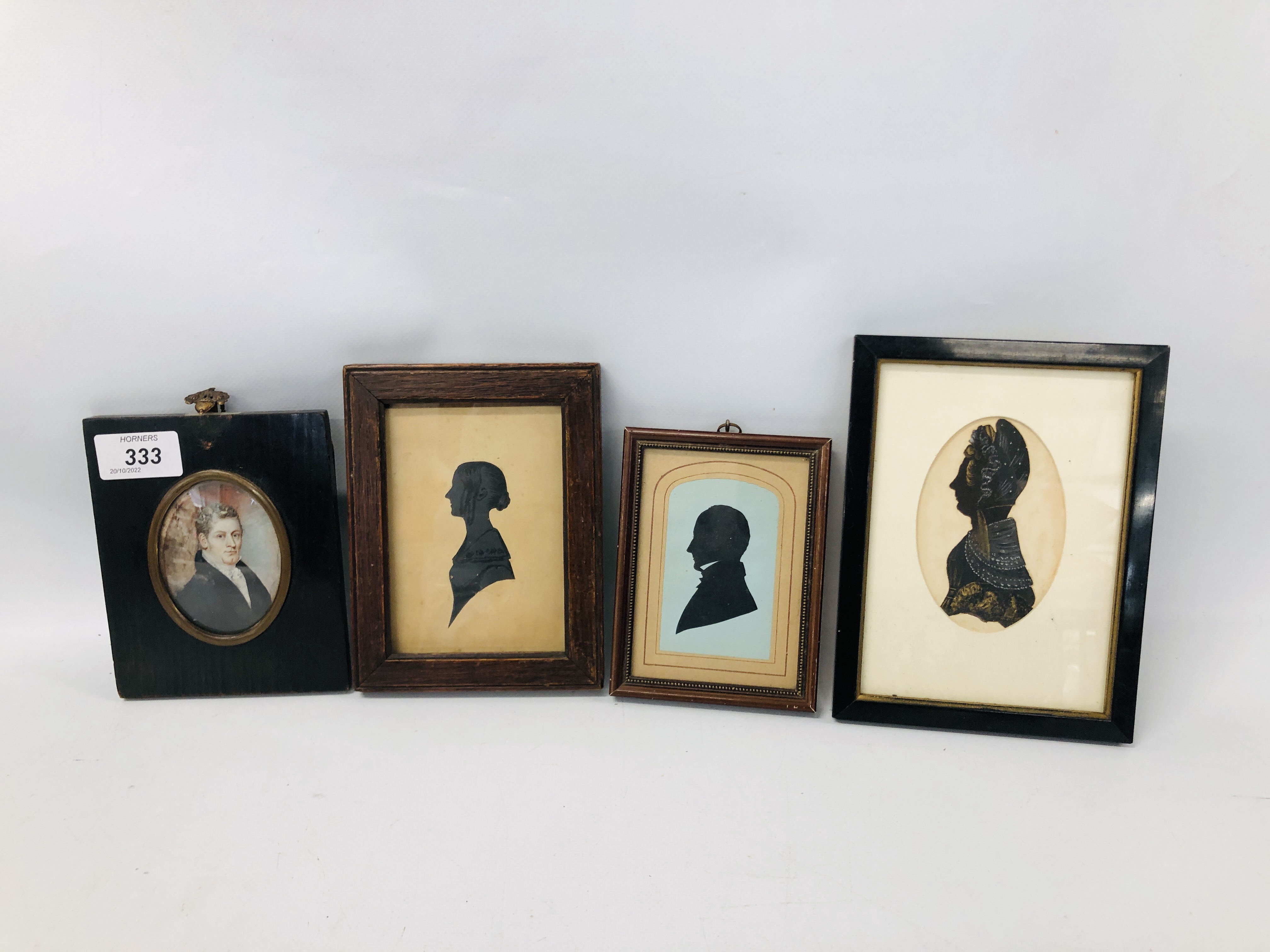 FOUR VINTAGE FRAMED SILHOUETTES TO INCLUDE A HANDCOLOURED IVORIAN EXAMPLE.