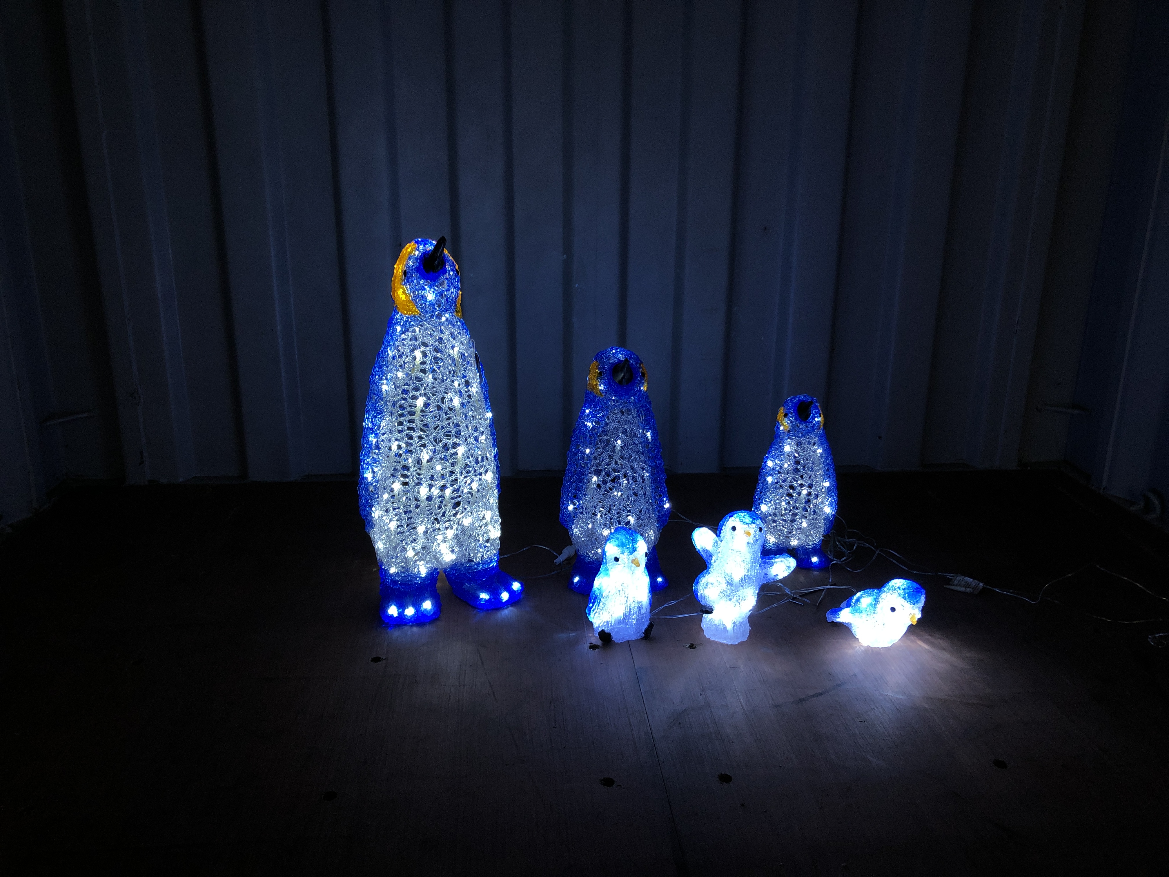 A GRADUATED SET OF THREE CHRISTMAS LED LIGHT UP PENGUINS (TALLEST 64CM.