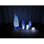 A GRADUATED SET OF THREE CHRISTMAS LED LIGHT UP PENGUINS (TALLEST 64CM.