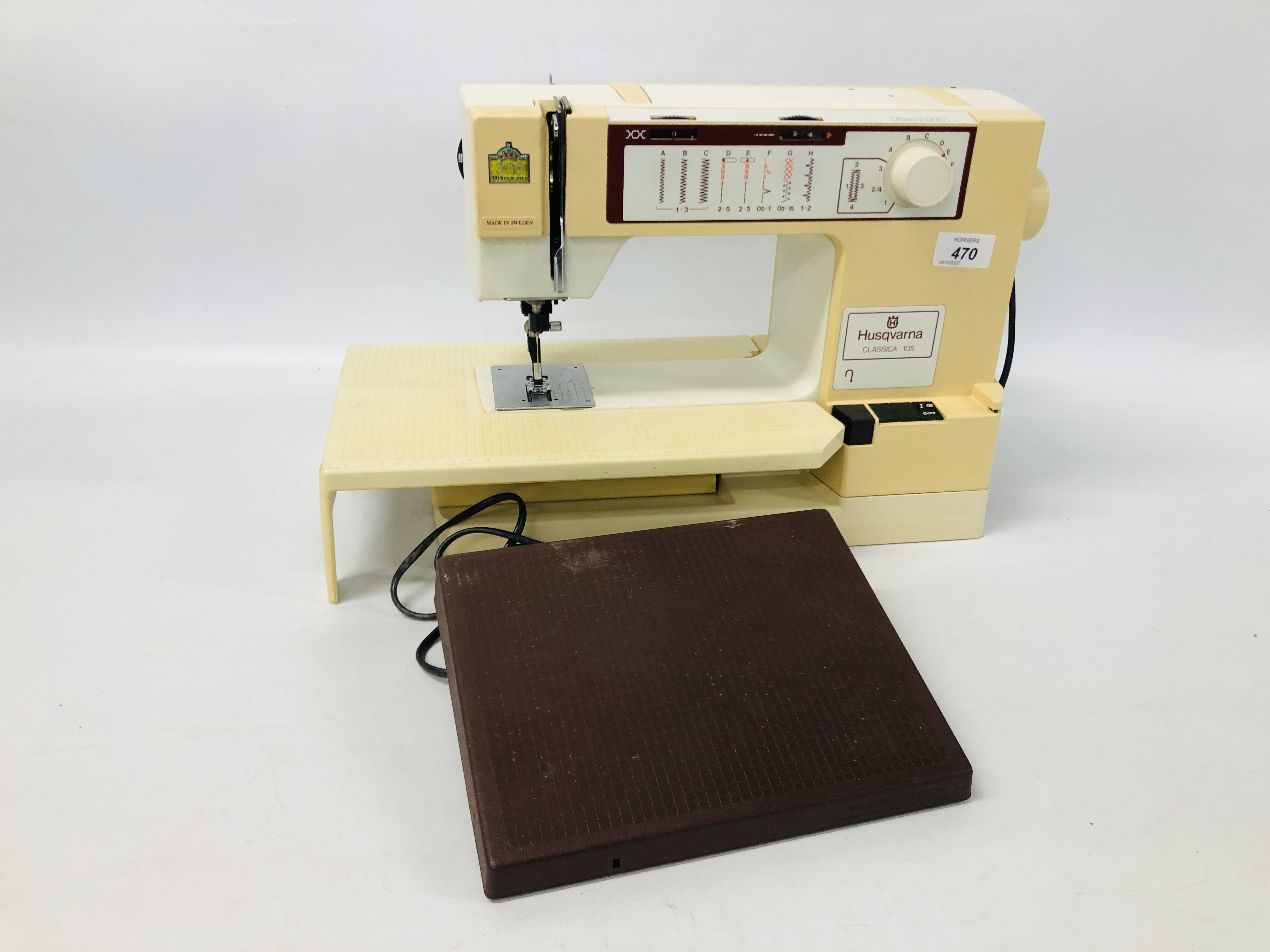 A HUSQVARNA CLASSICA SEWING MACHINE WITH FOOT PEDAL AND MANUAL - SOLD AS SEEN.