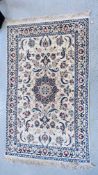 A PERSIAN DESIGN CARPET BEIGE GROUND WITH BLUE/RED PATTERN 205CM X 125CM.