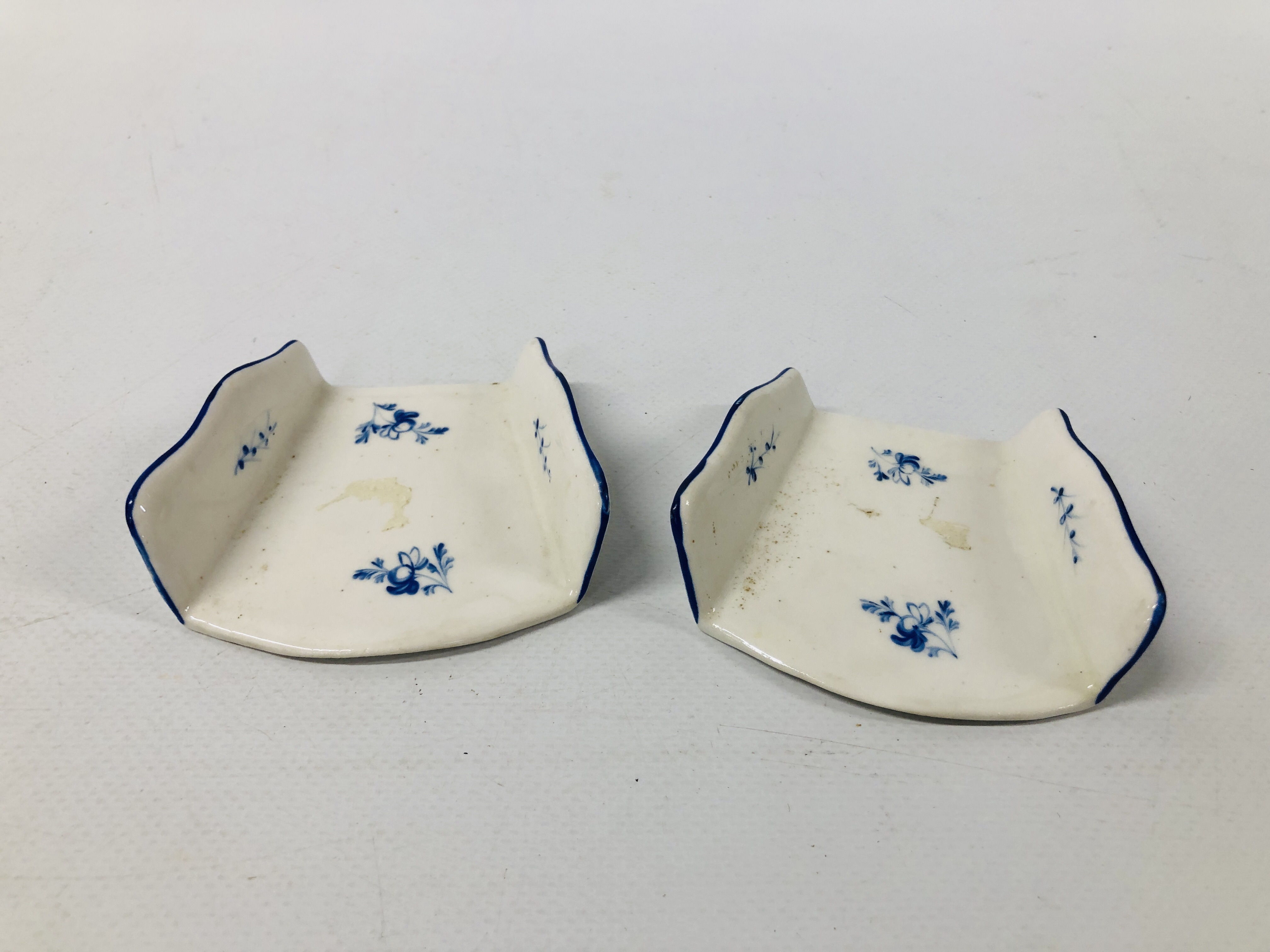 TWO DERBY ASPARAGUS SERVERS, OF FAN SHAPE, DECORATED IN DRY BLUE WITH SCATTERED SPRIGS, c.1780, 7.