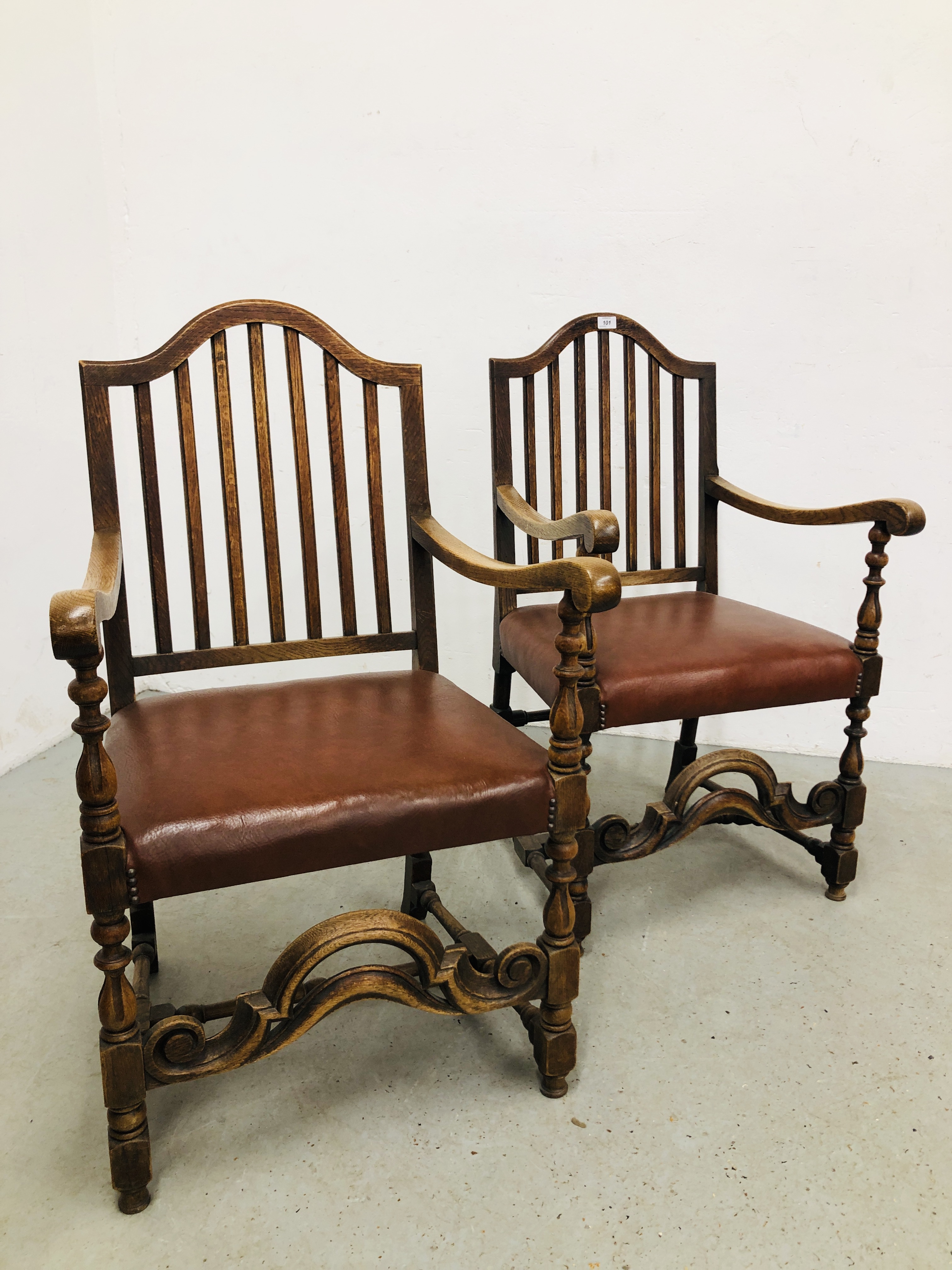 PAIR OF OAK FRAMED STRUNG BACK ELBOW CHAIRS WITH TANNED LEATHERETTE SEATS.