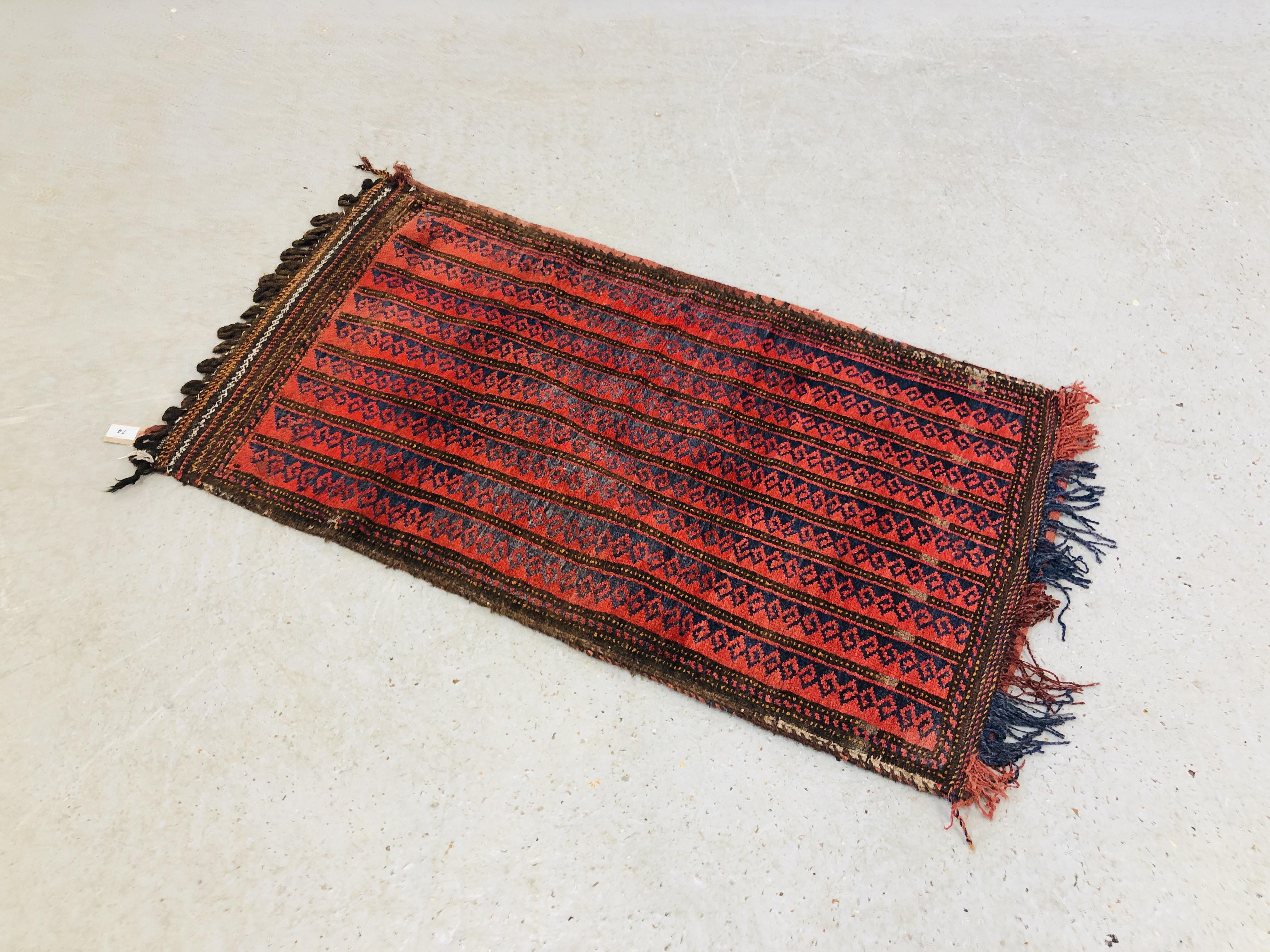 TURKOMAN CARPET BAG, THE ROWS OF HOOKED MOTIF ON A RED FIELD L108CM X W62CM.