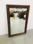 AN ELEGANT REPRODUCTION RECTANGULAR BEVELLED WALL MIRROR IN WALNUT FINISH FRAMEWORK 119CM X 79CM.