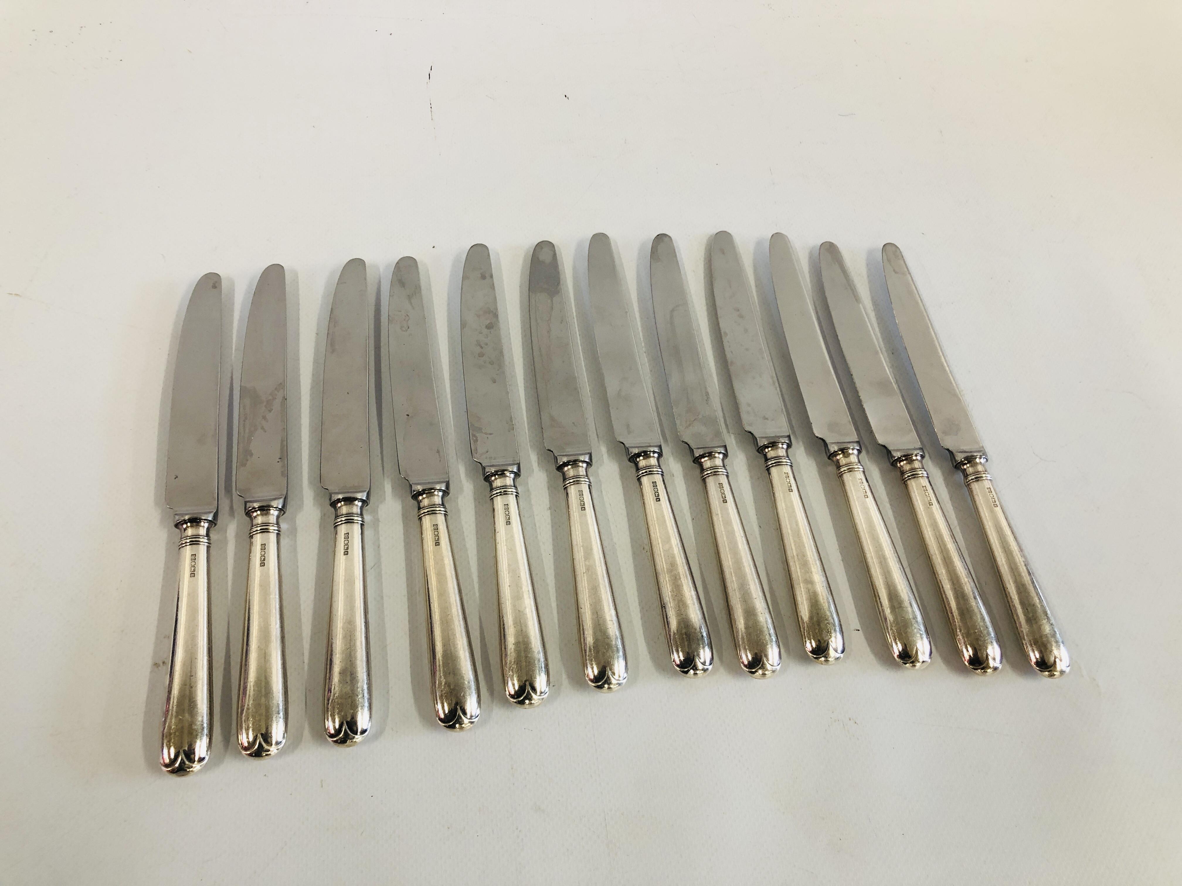 A SET 0F TWELVE SILVER HANDLED TABLE KNIVES