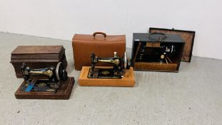 THREE VINTAGE SINGER SEWING MACHINES IN FITTED CARRY CASES.