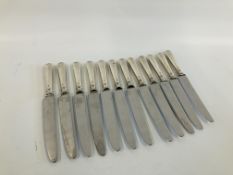 A SET OF TWELVE LARGE SILVER HANDLED TABLE KNIVES