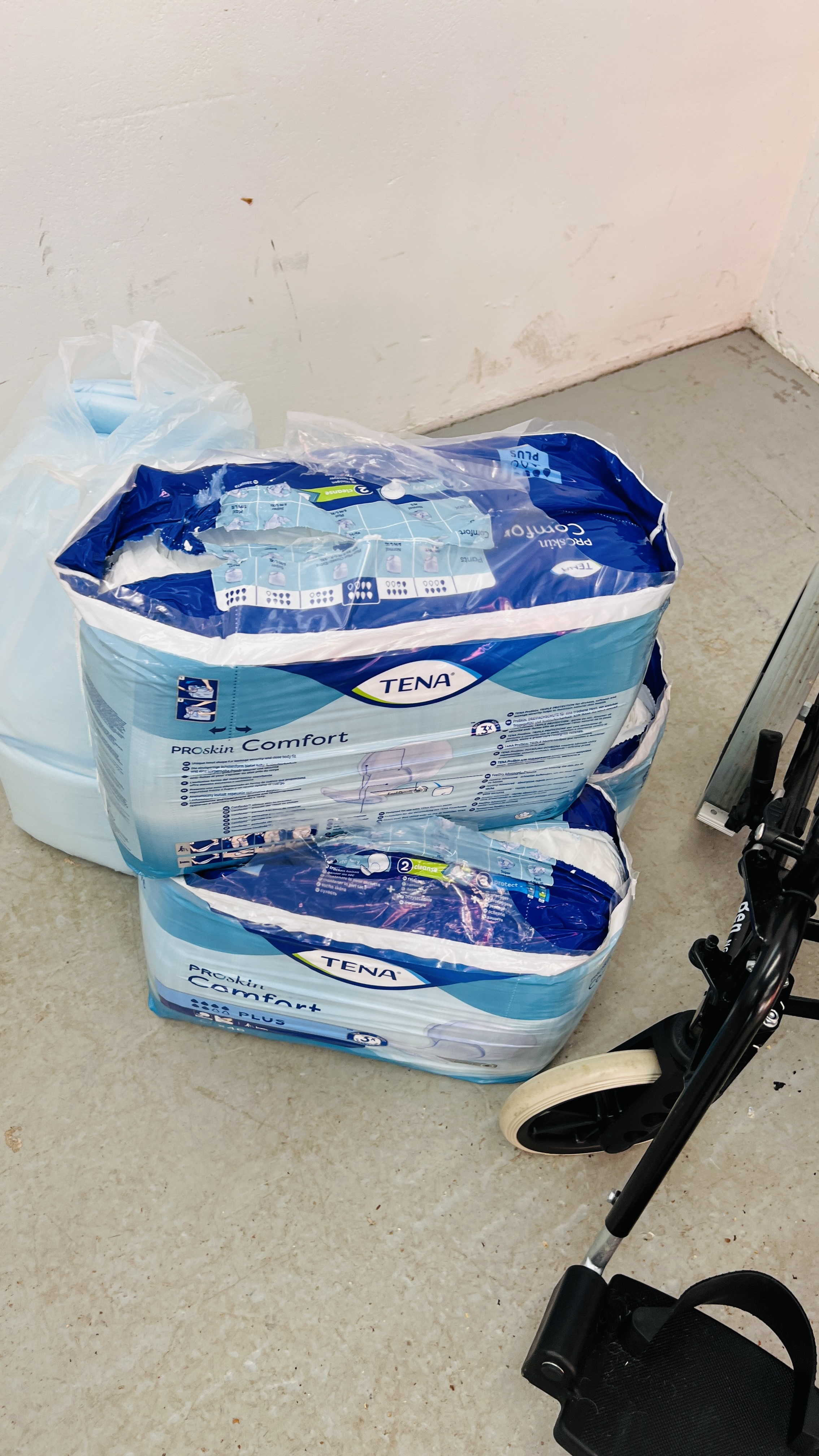 AN INVACARE COLLAPSIBLE WHEEL CHAIR AND THREE PACKS OF TENA PADS - Image 6 of 6