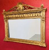 AN IMPRESSIVE GILT FINISH OVER MANTEL MIRROR WITH HEAVILY ORNATE DETAIL AND BEVELLED GLASS W 128CM,