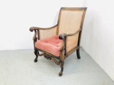 A PERIOD FRENCH BERGERE CHAIR WITH CARVED SCROLLED DETAIL AND CUSHIONED SEAT