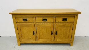 MODERN OAK THREE DRAWER THREE DOOR SIDEBOARD WITH BRASS EFFECT HANDLES WIDTH 139CM. DEPTH 42CM.