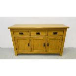 MODERN OAK THREE DRAWER THREE DOOR SIDEBOARD WITH BRASS EFFECT HANDLES WIDTH 139CM. DEPTH 42CM.