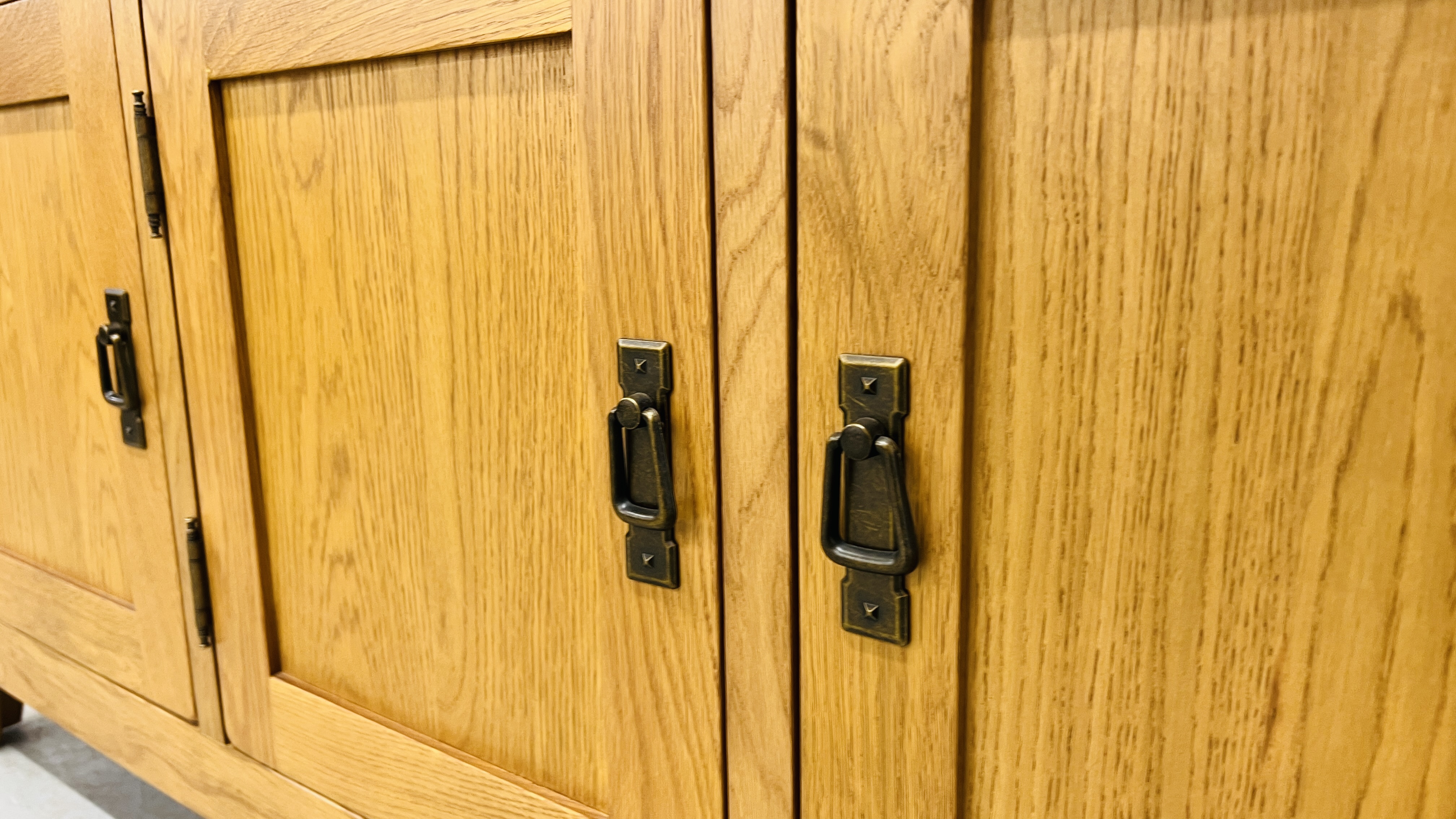 MODERN OAK THREE DRAWER THREE DOOR SIDEBOARD WITH BRASS EFFECT HANDLES WIDTH 139CM. DEPTH 42CM. - Image 9 of 13