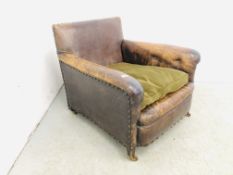 AN EDWARDIAN LEATHER ARMCHAIR WITH STUD DETAIL