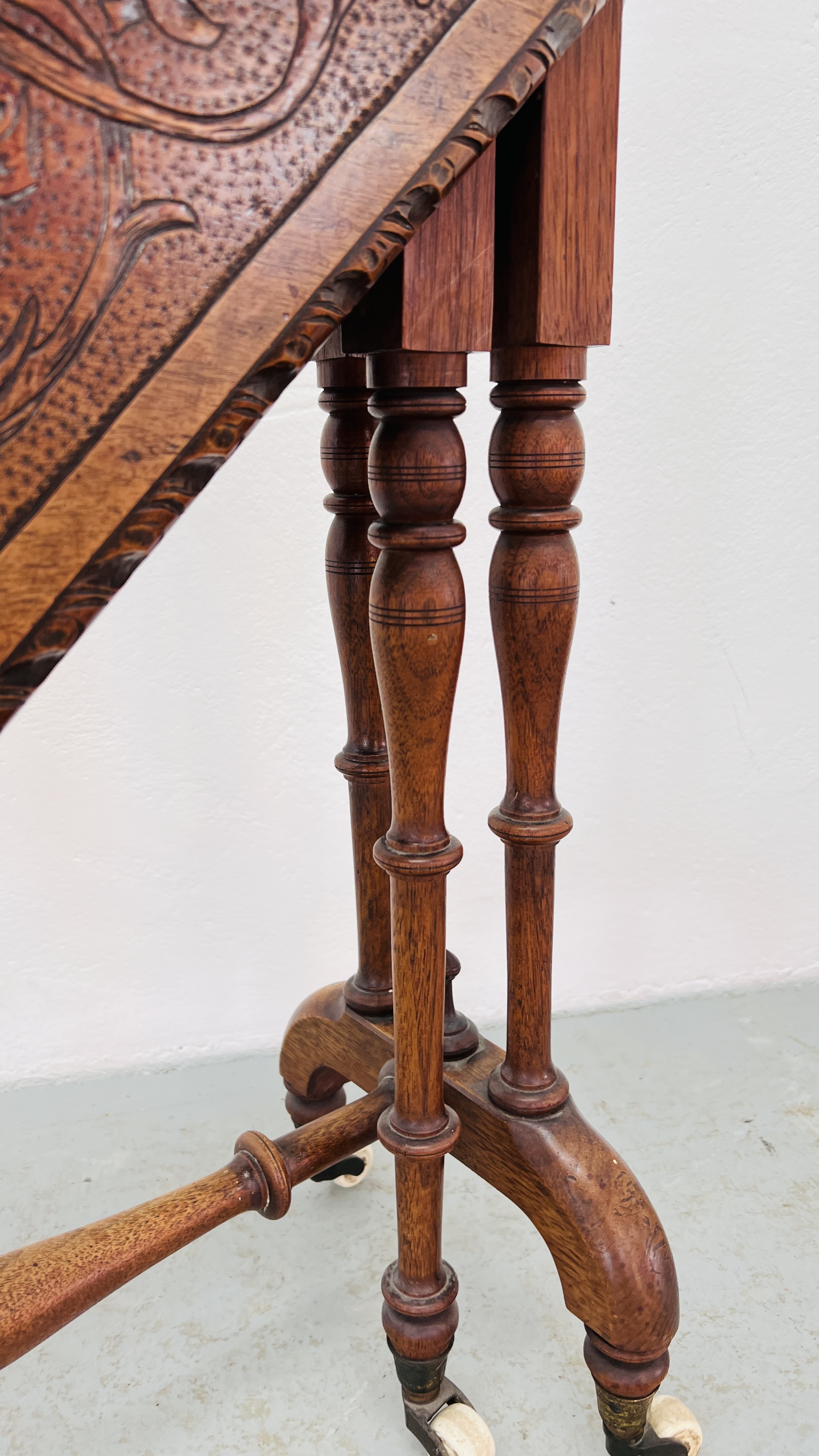 A MAHOGAY GATELEG OCCASIONAL TABLE WITH POKA ART DETAILING ON CERAMIC CASTORS WIDTH 77CM. X 75CM. - Image 6 of 8