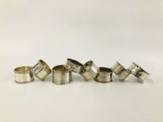 A GROUP OF FOUR SILVER NAPKIN RINGS ALONG WITH FOUR OTHERS UNMARKED