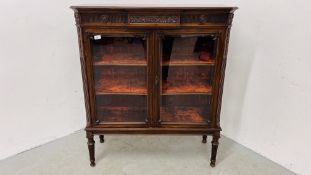 ANTIQUE MAHOGANY TWO DOOR GLAZED DISPLAY CABINET WITH VELVET UPHOLSTERED SHELVES STANDING ON REEDED