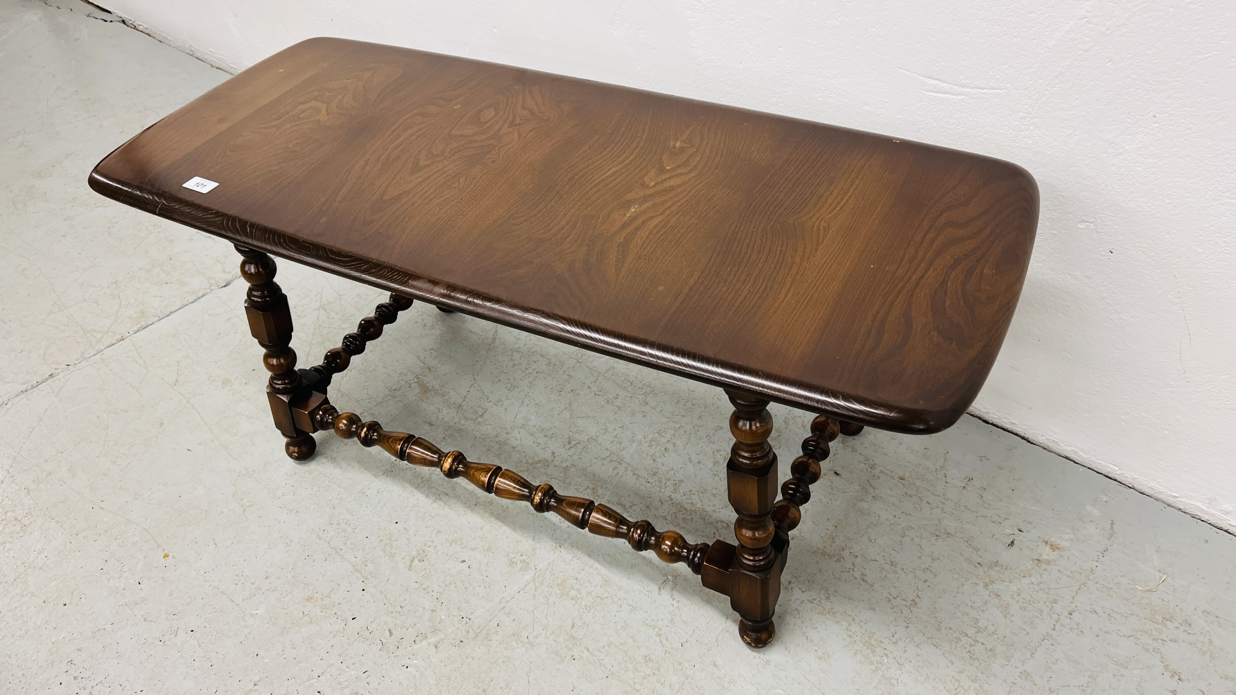 ERCOL RECTANGULAR COFFEE TABLE WITH TURNED SUPPORTS AND STRETCHERS WIDTH 45CM. LENGTH 104CM. - Image 7 of 7