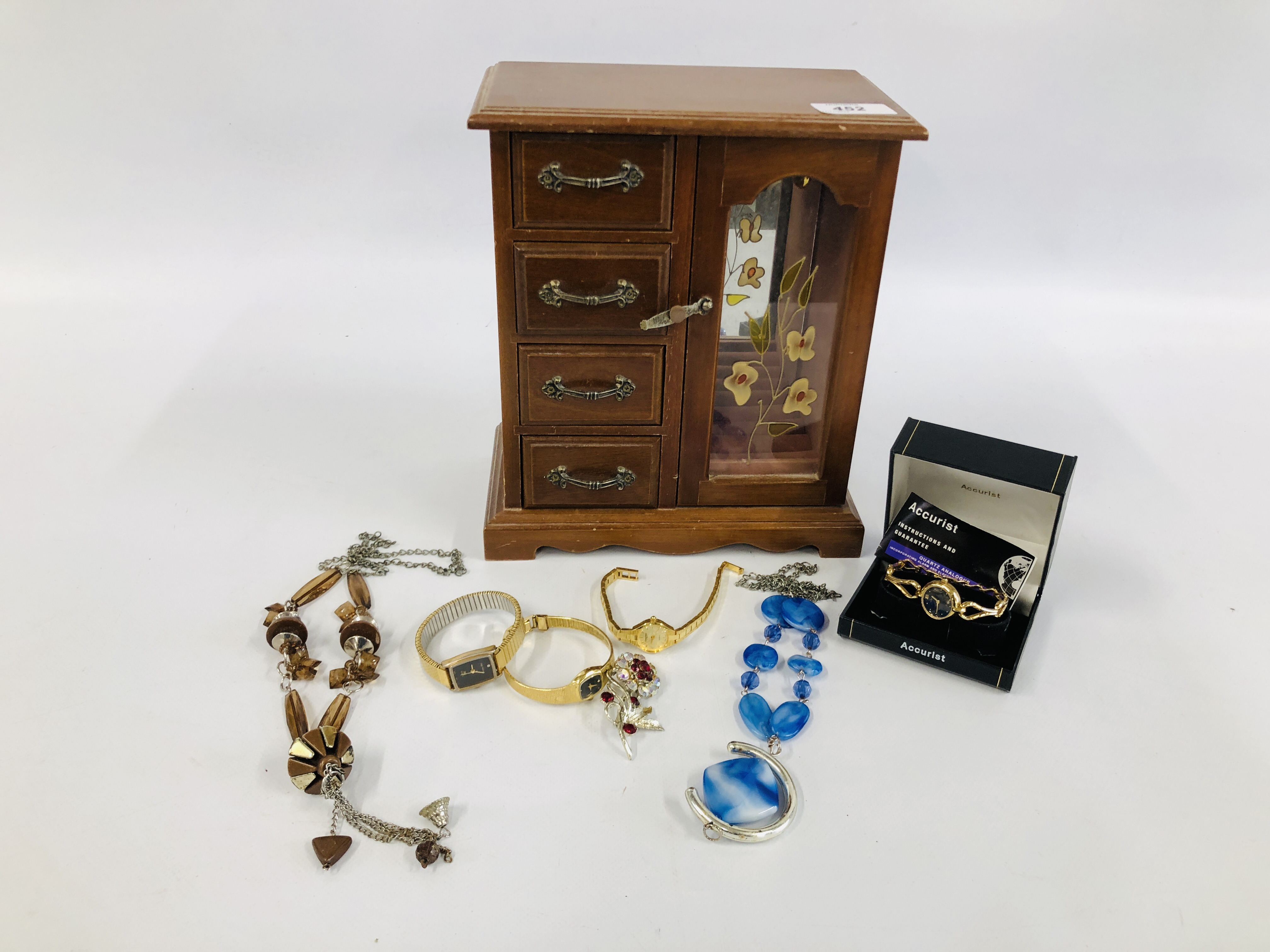 A MODERN FOUR DRAWER JEWELLERY CHEST WITH STAINGLASS PANEL AND CONTENTS TO INCLUDE NECKLACES,