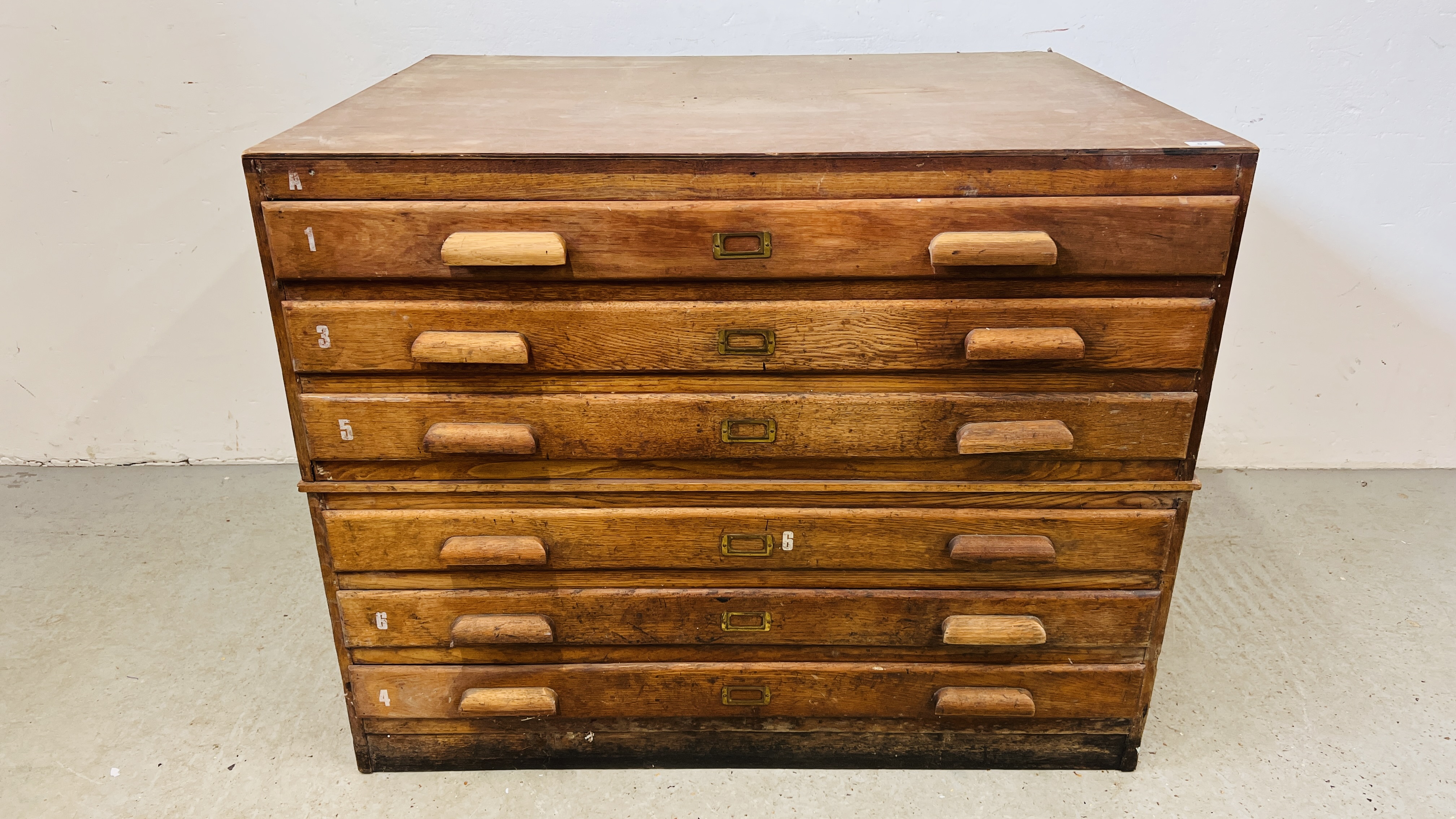 AN ANTIQUE OAK SIX DRAWER PLAN CHEST WIDTH 115CM. DEPTH 90CM. HEIGHT 90CM.