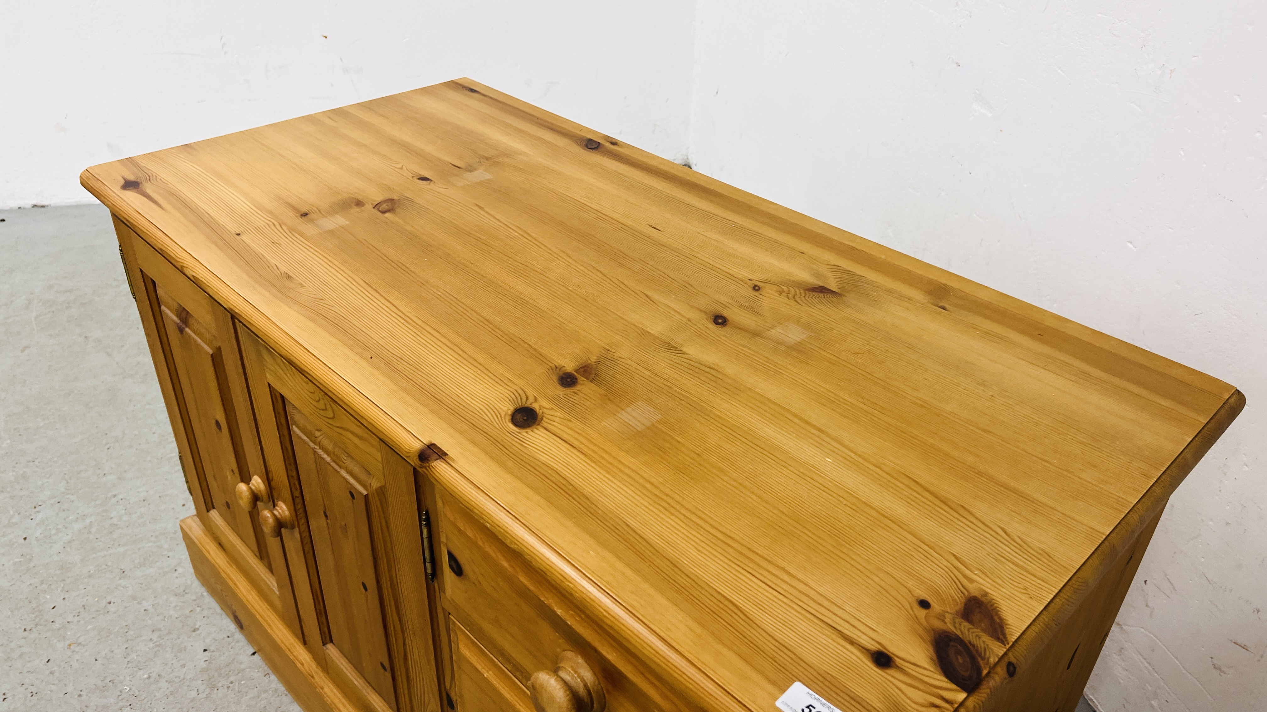 A SOLID WAXED PINE THREE DRAWER ENTERTAINMENT CABINET WIDTH 107CM. DEPTH 54CM. HEIGHT 65CM. - Image 5 of 9