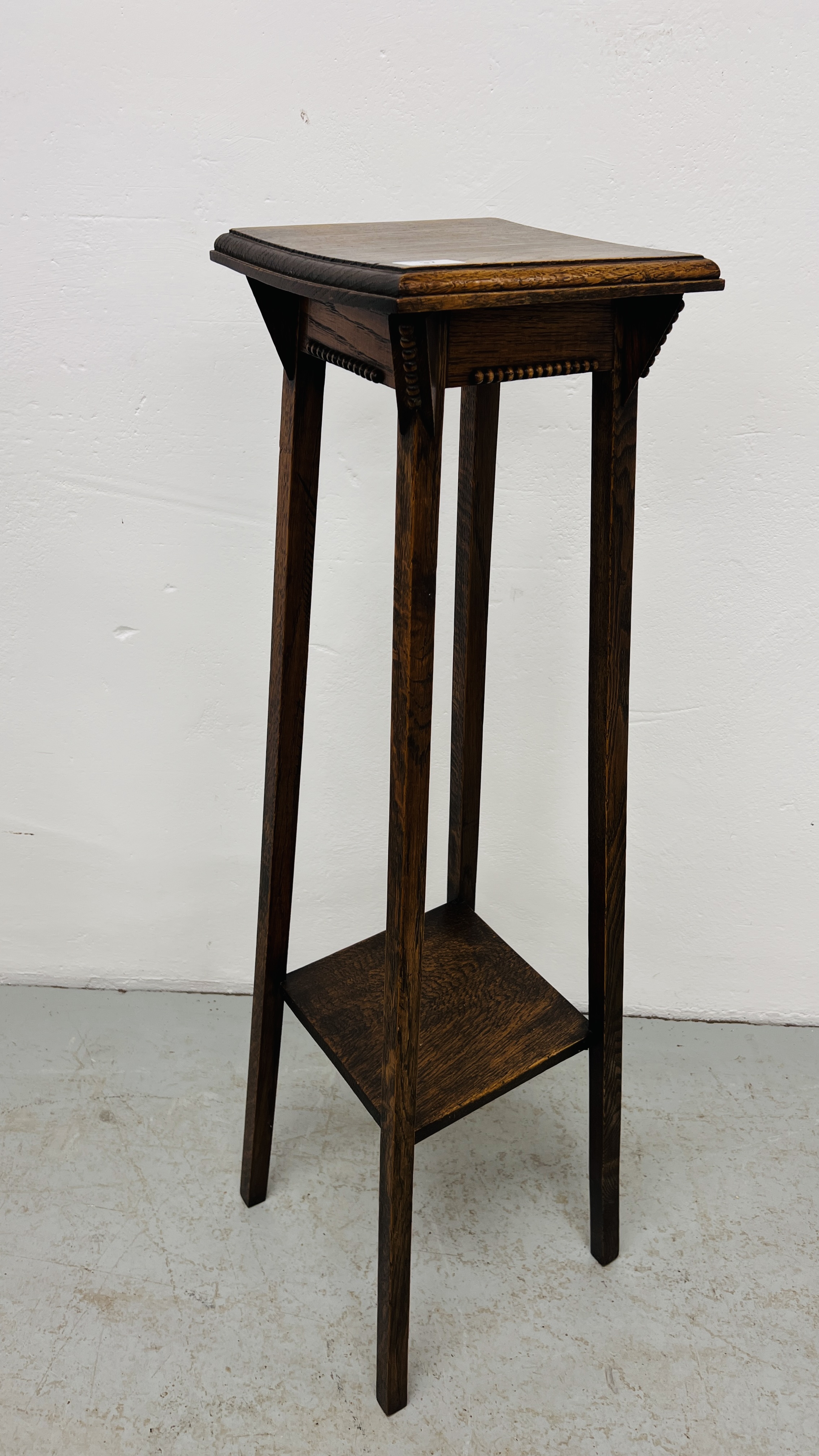 AN ARTS AND CRAFTS STYLE TWO TIER OAK PLANT STAND WIDTH 26CM. DEPTH 26CM. HEIGHT 102CM.