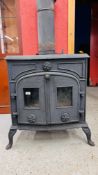 A LARGE CAST WOODBURNER W 69CM, D 54CM, H 78CM, COMPLETE WITH FLUE, 45° BEND APPROX 66CM.