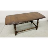 ERCOL RECTANGULAR COFFEE TABLE WITH TURNED SUPPORTS AND STRETCHERS WIDTH 45CM. LENGTH 104CM.