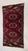 AZTEC DESIGN RUG ON RED BACKGROUND 132 X 65CM.