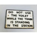 A REPRODUCTION CAST IRON "DO NOT USE THE TOILET WHILE THE TRAIN IS STANDING IN THE STATION" SIGN