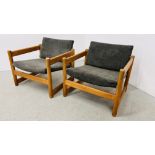 A PAIR OF MID CENTURY LOW ARMCHAIRS WITH RUBBER CUSHION SUPPORTS STAMPED PIRELLI
