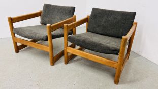 A PAIR OF MID CENTURY LOW ARMCHAIRS WITH RUBBER CUSHION SUPPORTS STAMPED PIRELLI