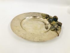 A SILVER CIRCULAR DISH WITH HAMMERED RIM APPLIED WITH A BASE METAL STRAWBERRY PLANT AND INSECT