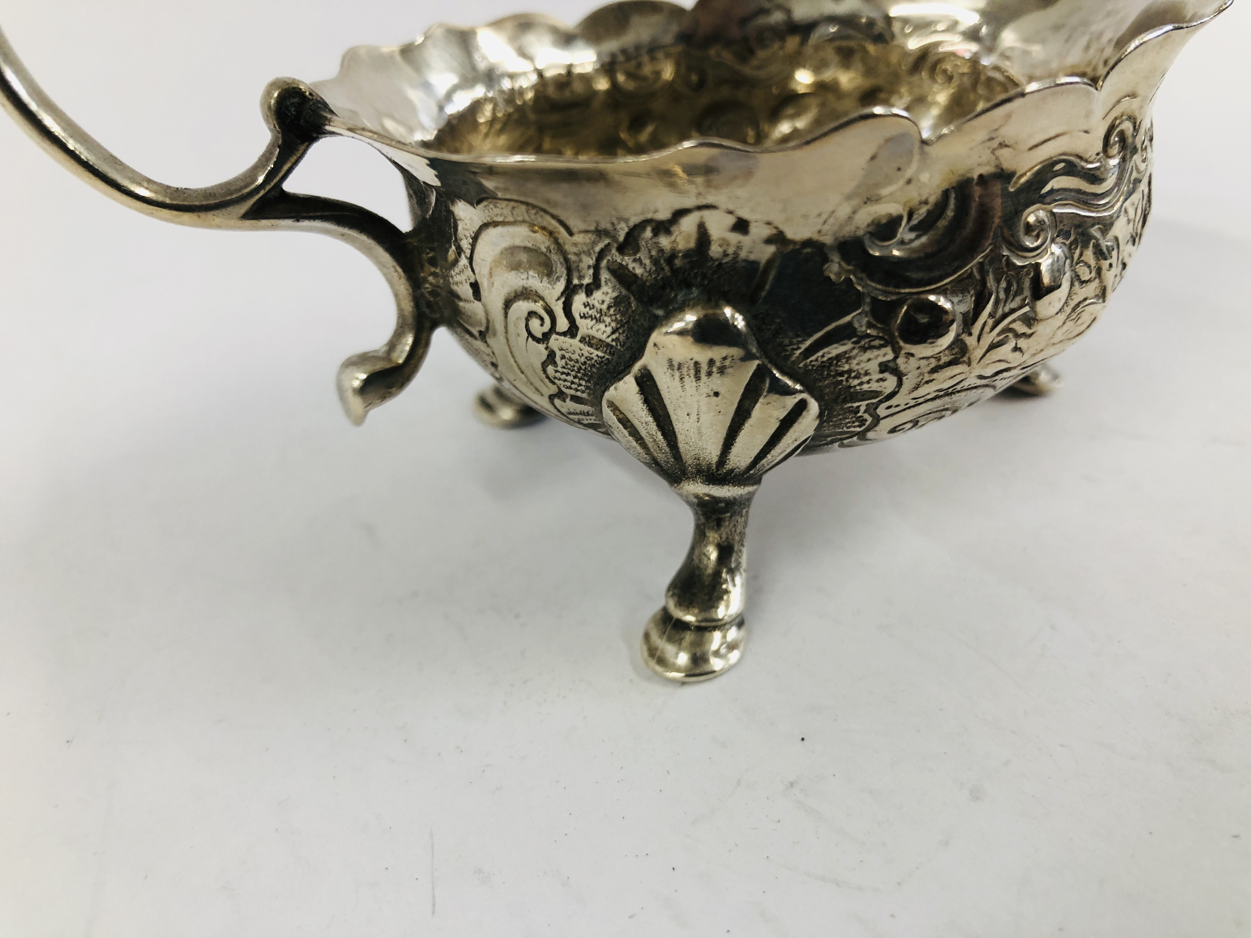 A GEORGE II SILVER CREAM BOAT WITH OPEN SCROLLED HANDLE THE BODY DECORATED WITH GEESE ON TRIPOD - Image 3 of 10