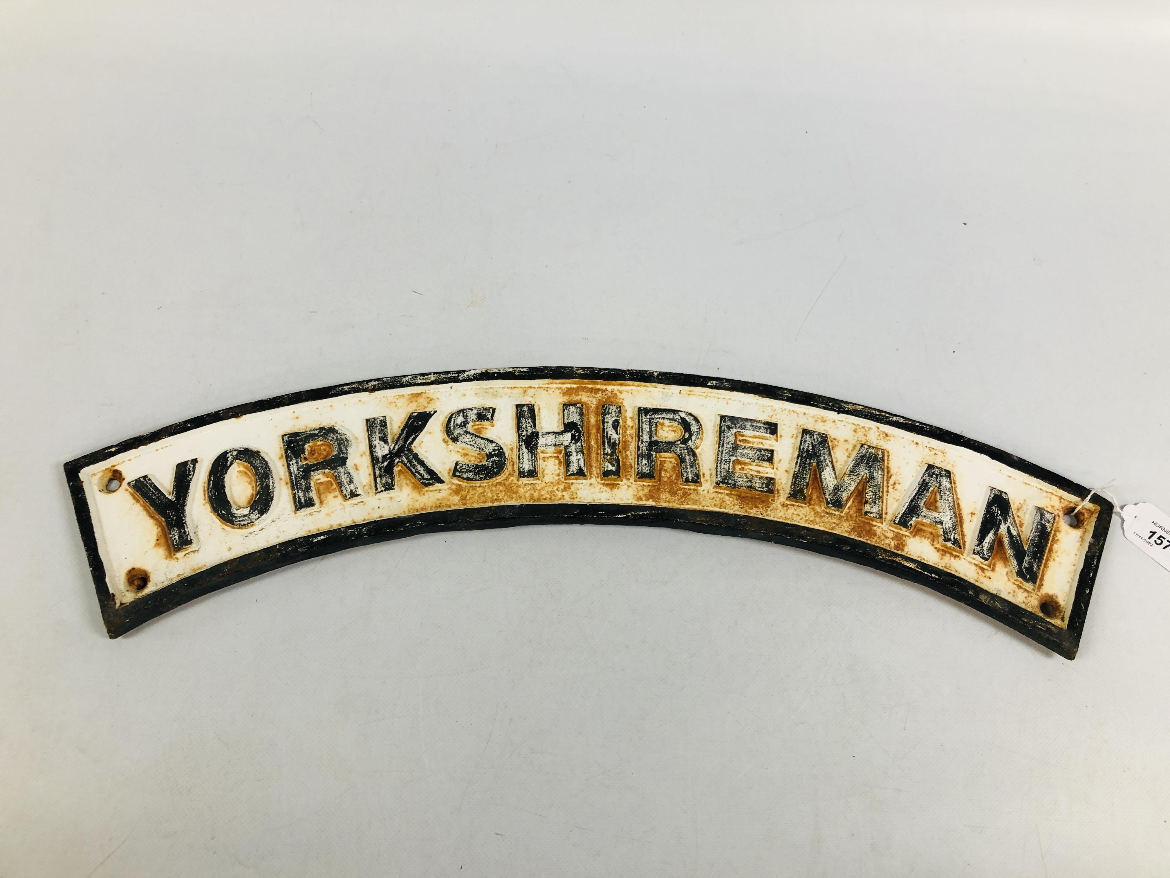 A REPRODUCTION CAST IRON "YORKSHIRE MAN" CURVED PLAQUE WIDTH 65CM.