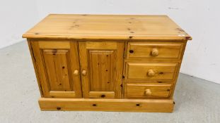 A SOLID WAXED PINE THREE DRAWER ENTERTAINMENT CABINET WIDTH 107CM. DEPTH 54CM. HEIGHT 65CM.