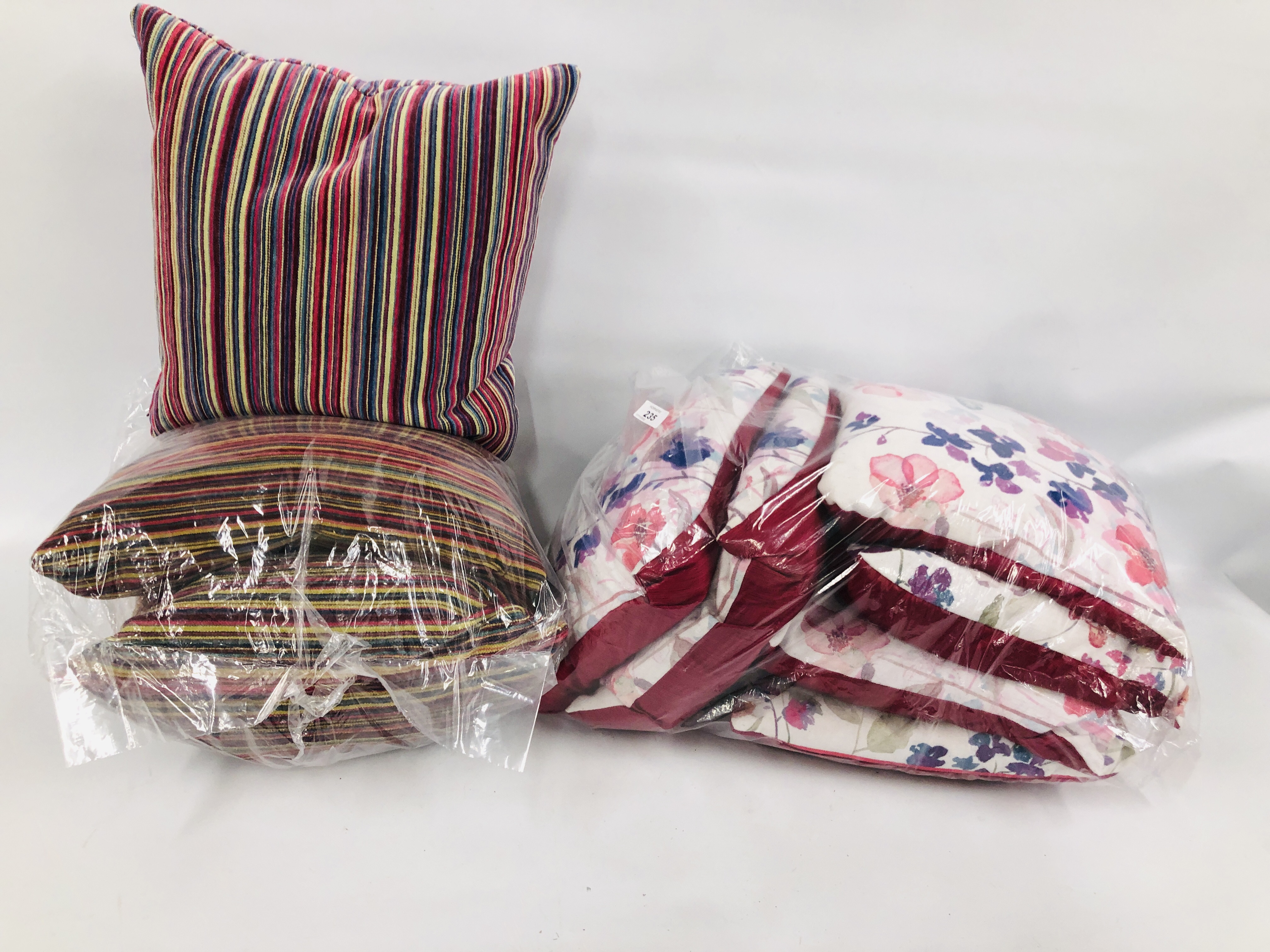 SIX MATCHING SATIN AND FABRIC BUTTERFLY / FLORAL DECORATED CUSHIONS AND THREE STRIPED CUSHIONS.