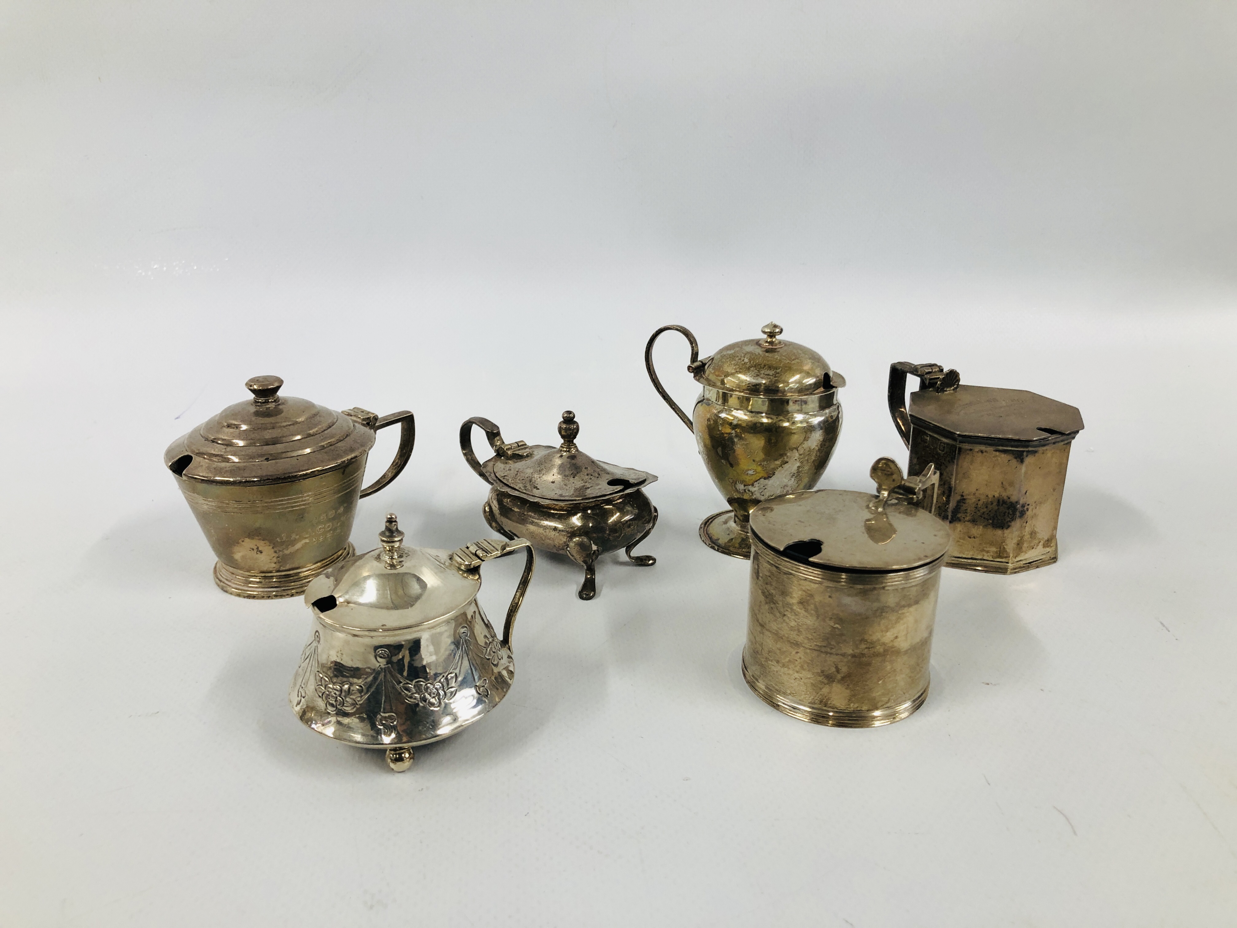 A GROUP OF SIX VARIOUS SILVER MUSTARDS ALL WITH HINGED COVERS AND LINERS VARIOUS ASSAY AND MAKERS