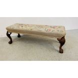 A MAHOGANY FRAMED DOUBLE FOOTSTOOL WITH TAPESTRY UPHOLSTERED CUSHIONED SEAT, BALL AND CLAW FEET,