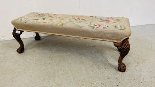 A MAHOGANY FRAMED DOUBLE FOOTSTOOL WITH TAPESTRY UPHOLSTERED CUSHIONED SEAT, BALL AND CLAW FEET,