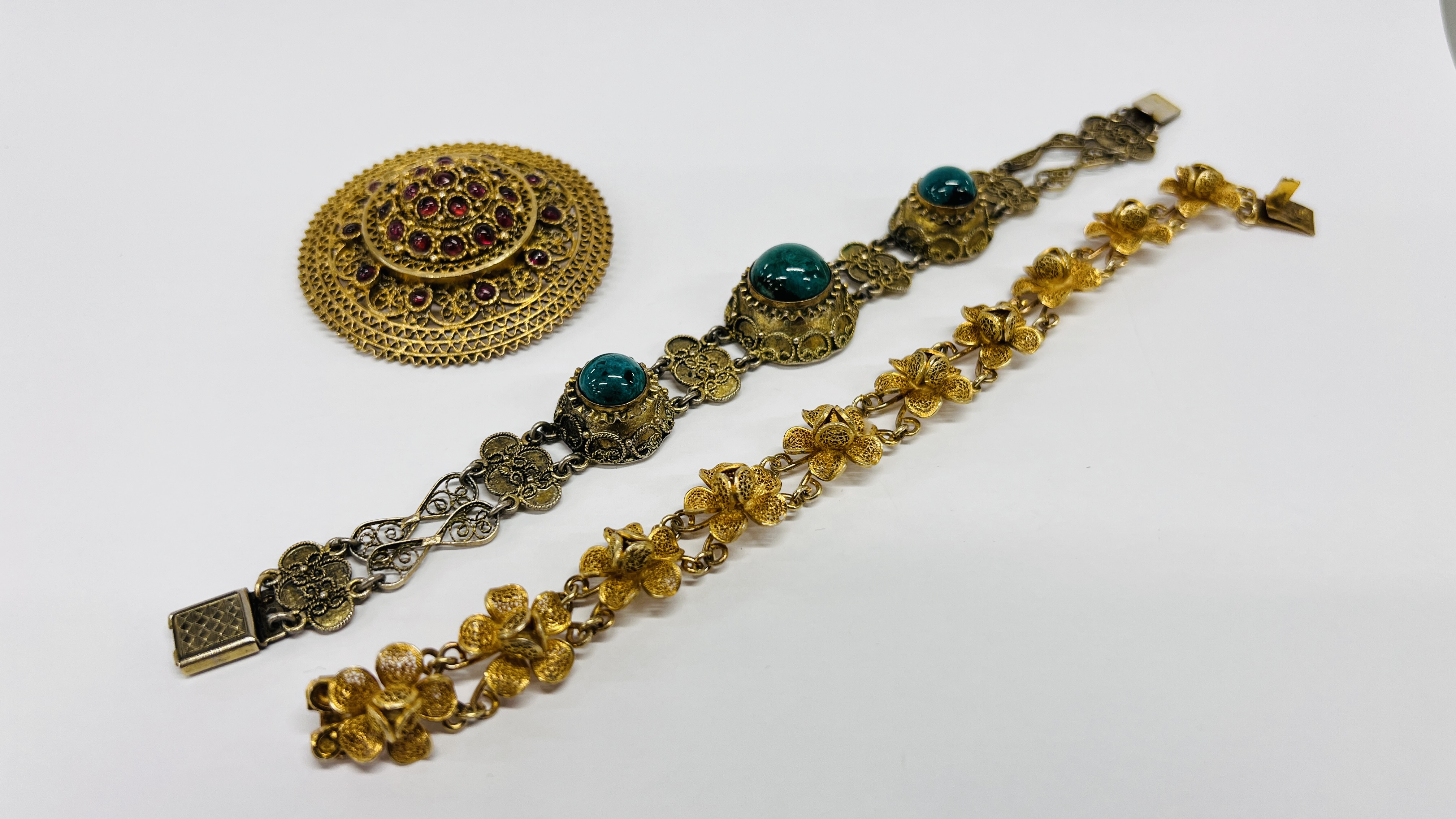 A SILVER GILT BROOCH MADE IN ISRAEL, SET WITH CABOCHONS,